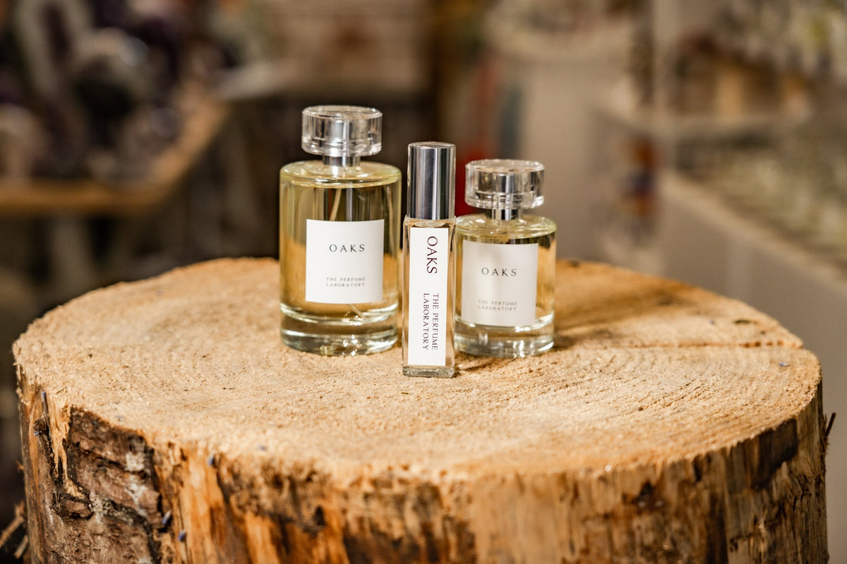 Oaks perfume bottles photographed in our shop on a natural wooden display